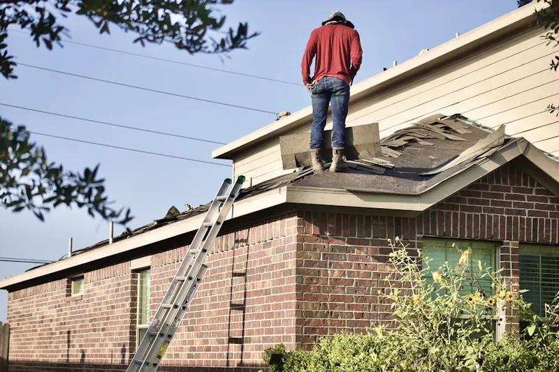 Professional roofer working on a residential roof in Riverwinds